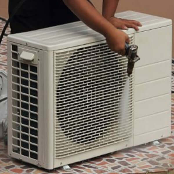 Aircon technician servicing an Air Conditioner by Aircons 24